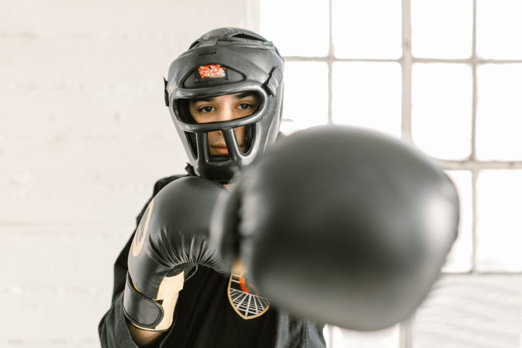 Full-face red boxing head guard with cheek protection